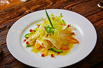 Image showing salad of celery, avocado and persimmon with greens 