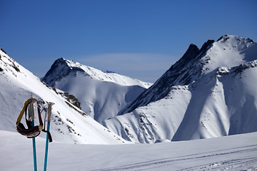 Image showing Ski mask on ski poles and off-piste slope