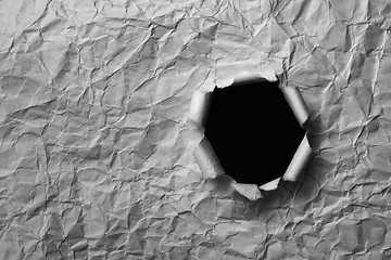 Image showing Gray sheet ofcrumpled paper with a hole