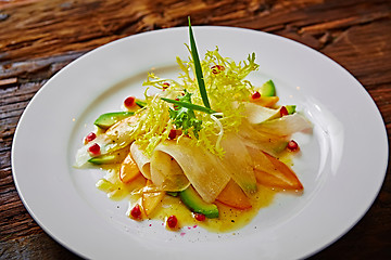 Image showing salad of celery, avocado and persimmon with greens 