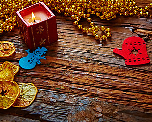 Image showing Seasonal rustic Christmas border composed of ornaments over a wooden background with copyspace, overhead view