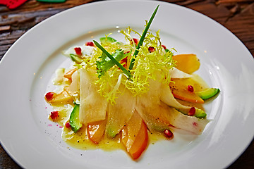 Image showing salad of celery, avocado and persimmon with greens 