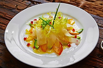 Image showing salad of celery, avocado and persimmon with greens 