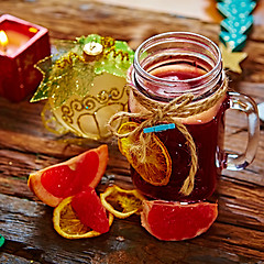 Image showing Mulled wine and spices on wooden background. 