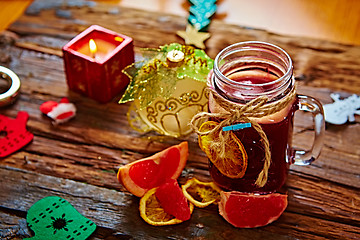 Image showing Mulled wine and spices on wooden background. 
