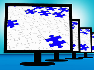 Image showing Unfinished Puzzle On Monitors Showing Lost Pieces