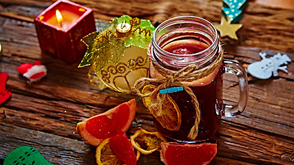 Image showing Mulled wine and spices on wooden background. 