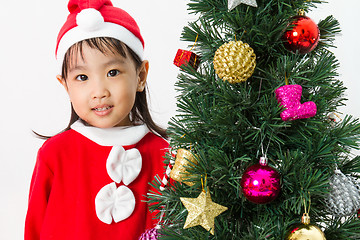 Image showing Asian Chinese little girl posing with Christmas Tree