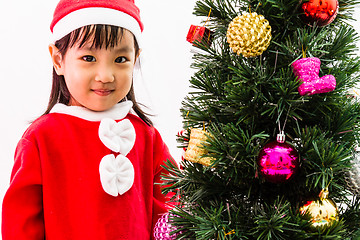 Image showing Asian Chinese little girl posing with Christmas Tree