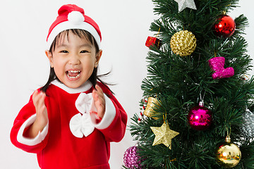 Image showing Asian Chinese little girl posing with Christmas Tree