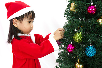 Image showing Asian Chinese little girl posing with Christmas Tree