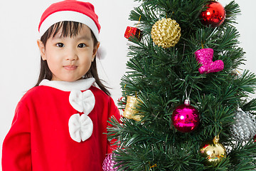 Image showing Asian Chinese little girl posing with Christmas Tree