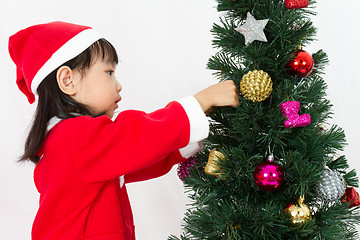 Image showing Asian Chinese little girl posing with Christmas Tree