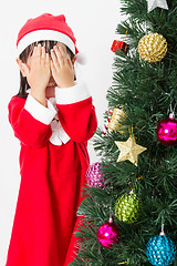 Image showing Asian Chinese little girl posing with Christmas Tree