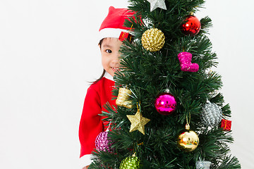 Image showing Asian Chinese little girl posing with Christmas Tree