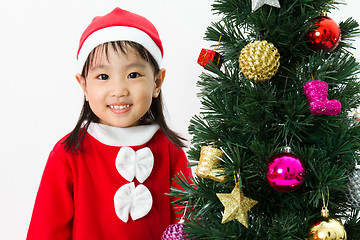 Image showing Asian Chinese little girl posing with Christmas Tree