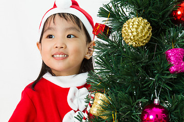 Image showing Asian Chinese little girl posing with Christmas Tree