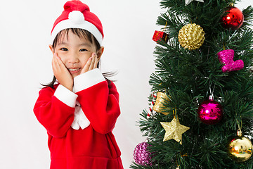 Image showing Asian Chinese little girl posing with Christmas Tree