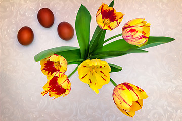 Image showing Bouquet yellow tulips and Easter eggs.