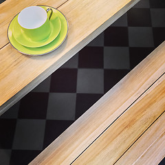 Image showing Green cup on a wooden table