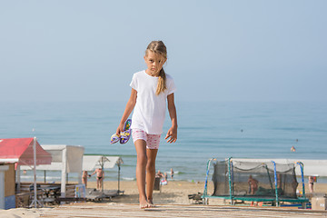 Image showing Six year old girl walking on wooden flooring from the sea home