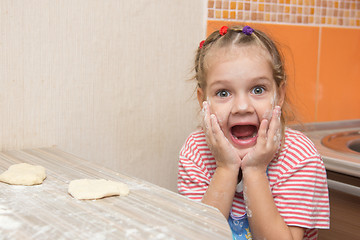 Image showing Cheerful girl mired in agony with his mouth open looking into the frame