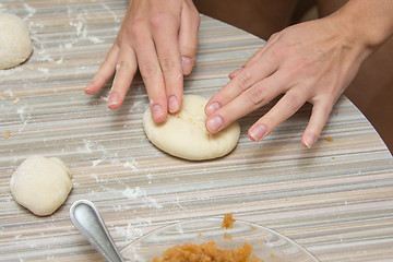 Image showing She sculpts cake, close-up