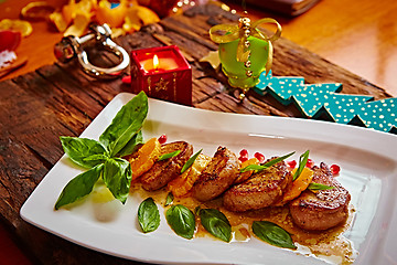 Image showing Grilled pork with mandarin oranges decorated and basil 