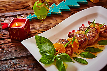 Image showing Grilled pork with mandarin oranges decorated and basil 