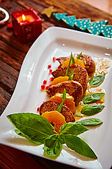 Image showing Grilled pork with mandarin oranges decorated and basil 