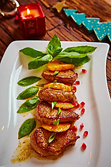 Image showing Grilled pork with mandarin oranges decorated and basil 