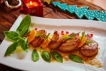 Image showing Grilled pork with mandarin oranges decorated and basil 