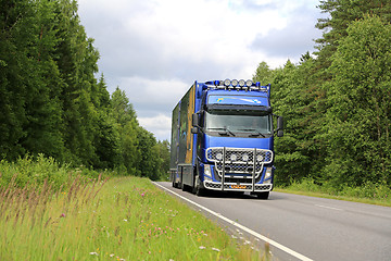 Image showing Blue Volvo FH Flower Transport Truck on Summer Road