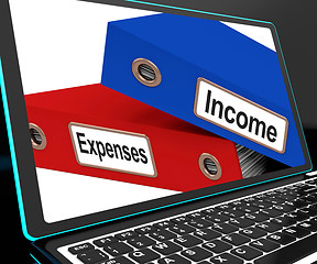 Image showing Income And Expenses Files On Laptop Shows Budgeting