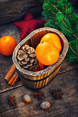 Image showing Wooden bucket with tangerines