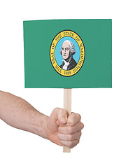 Image showing Hand holding small card - Flag of Washington