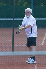 Image showing Senior man playing tennis