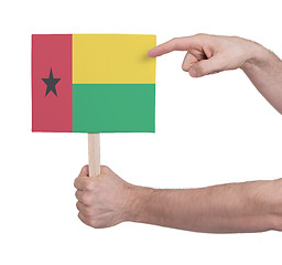 Image showing Hand holding small card - Flag of Guinea Bissau