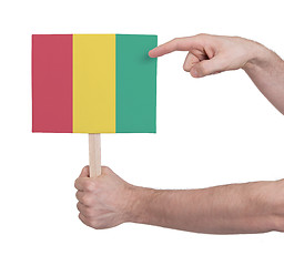 Image showing Hand holding small card - Flag of Guinea