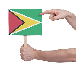 Image showing Hand holding small card - Flag of Guyana