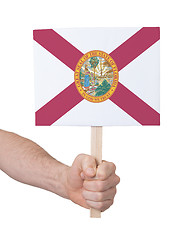 Image showing Hand holding small card - Flag of Florida