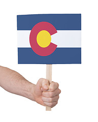 Image showing Hand holding small card - Flag of Colorado