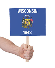 Image showing Hand holding small card - Flag of Wisconsin