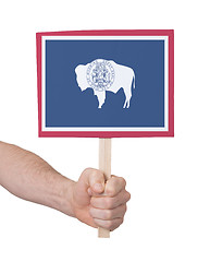 Image showing Hand holding small card - Flag of Wyoming