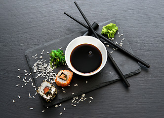 Image showing Rolls with sauce and chopsticks