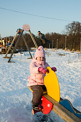 Image showing  Children swinging on a swing 