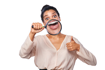 Image showing Woman smiling and show teeth through a magnifying glass