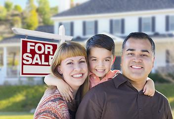 Image showing Young Family in Front of For Sale Sign and House