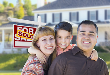 Image showing Young Family in Front of Sold Real Estate Sign and House