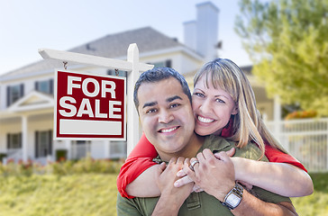 Image showing Couple in Front of For Sale Sign and House